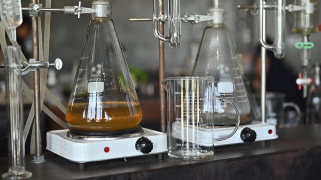 Laboratory Glass Distillation Apparatus with Separatory Funnel and Beaker for Chemical Extraction Process