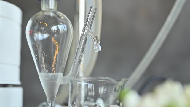 Laboratory Glass Distillation Apparatus with Separatory Funnel and Beaker for Chemical Extraction Process