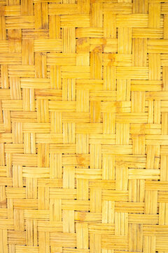 Traditional woven bamboo texture with geometric natural pattern creating rustic abstract background inspired by Indonesian handmade craftsmanship.