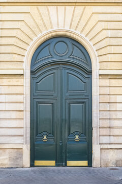 Paris, a wooden door rue de Babylone, typical building in the 7th arrondissement, a luxury district
