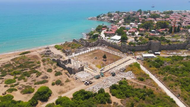 Side, Manavgat, Turkey. Ancient Agora Square, wide aerial view over stone ruins and colonnaded foundations on the Mediterranean coast, bright summer daylight. Aerial View, Departure of the camera, Ma