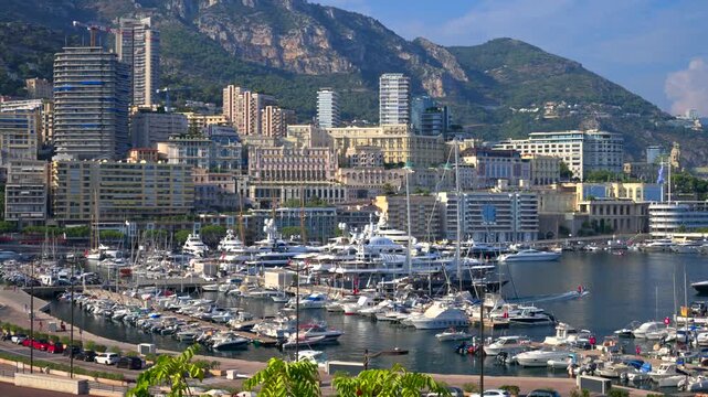 Panoramic view of Port Hercules with luxury yachts and Monte Carlo skyline in Monaco.