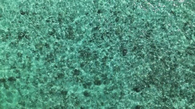 Aerial View of Shattered Safety Glass with Turquoise Hue Abstract Pattern and Textured Surface Creating Serene Effect