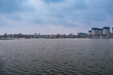 Fototapeta premium Snow Scenery of Hailong Lake Scenic Area in Meihekou, Jilin Province, China – Urban Ecological Park and Lakeside Landscape Covered in Late Spring Snow – April 4, 2026