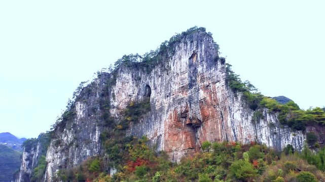 Karst Limestone Cliffs Above Forested Mountain Slope