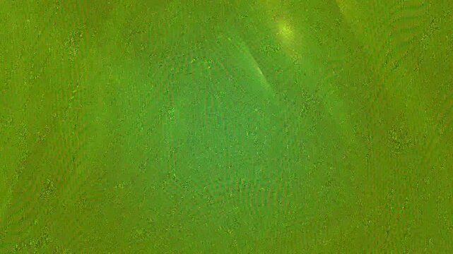 Close-up of shimmering green glitter texture with subtle diagonal lines