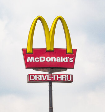 McDonald's restaurant drive-thru road sign under clear sky in Yogyakarta, Indonesia, 16 May 2026