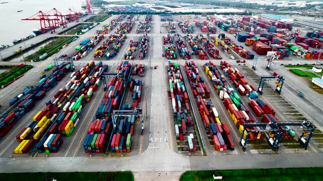 Busy container port with cranes and stacked cargo containers