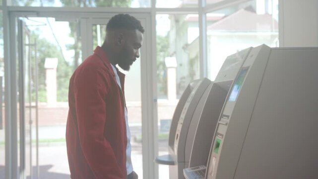 Urban banking routine, Individual completes daily banking process at ATM within contemporary bank setting
