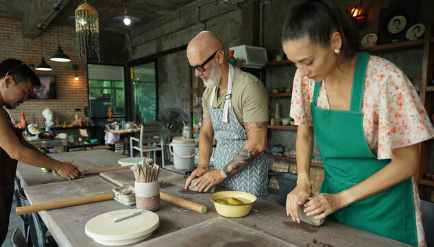 A happy couple makes ceramic plates in a workshop