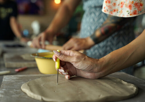 A happy couple makes ceramic plates in a workshop