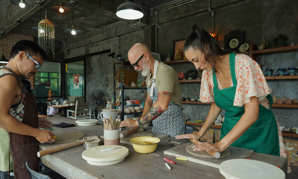 A happy couple makes ceramic plates in a workshop