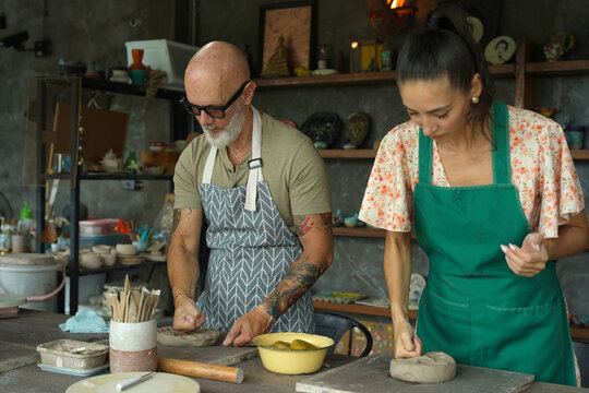 A happy couple makes ceramic plates in a workshop