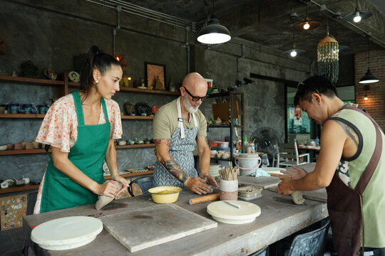 A happy couple makes ceramic plates in a workshop