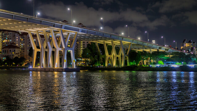 Night cityscape with Benjamin Sheares Bridge in Singapore. This is the longest and highest bridge, Singapore. The bridge opened in 1981 and is named after Singapore's second president, Benjamin Shears