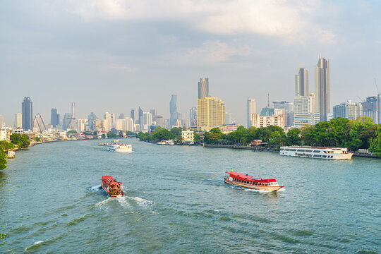 Tourist boats sailing along the Chao Phraya River in Bangkok