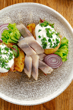 Gourmet pickled herring appetizer with roasted potatoes