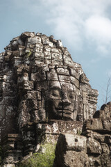 Fototapeta premium Close-Up of Carved Stone Face Tower at Bayon Temple in Angkor Wat, Cambodia