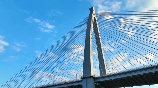 Modern Cable-Stayed Bridge Tower Against Blue Sky