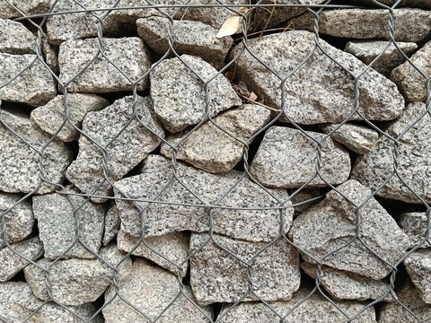 stone wall background
Stone gabion texture background with metallic grid