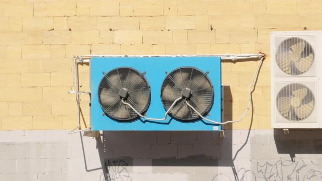 air conditioning, blue condenser unit, compressor on facade of building. central air conditioning unit of HVAC ventilation air conditioning system. seasonal temperature rise. high-quality 4k video