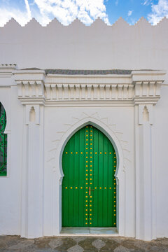 Green medina door with Moorish architecture in Asilah Morocco
