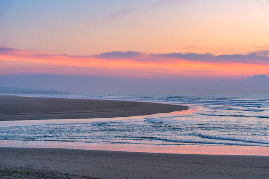Scenic beach at sunset showing the Morocco coastline