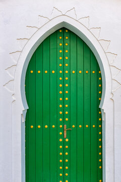 Green medina door with Moorish architecture in Asilah Morocco