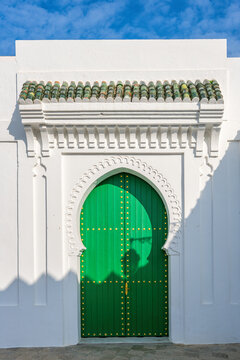 Green medina door with Moorish architecture in Asilah Morocco
