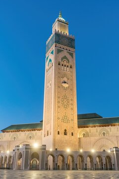 Illuminated minaret of Hassan II Mosque at twilight in Casablanca