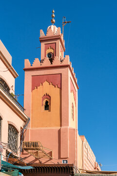 Colorful Moroccan minaret against a clear blue sky in Marrakech
