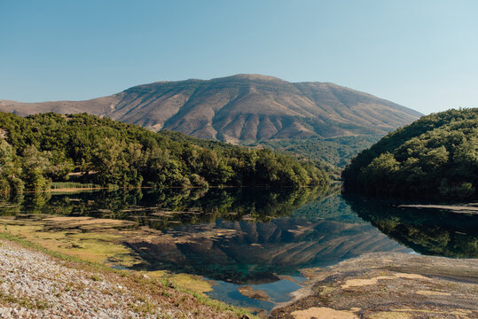 Mountain reflection in spring lake at Syri i Kalt&euml;r, Albania