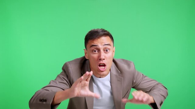 Young businessman shouting an announcement on green screen