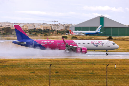 Luqa, Malta - May 17, 2026: Wizz Air Airbus A321-271NX (Reg.: HA-LDL) one of the new NEO A321 with Wizz braking on a wet runway.