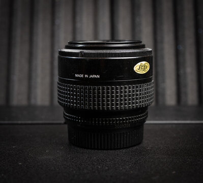 Gothenburg, Sweden - March 13 2026: Rear view of Nikon AF Nikkor zoom lens highlighting Japanese made vintage camera gear.