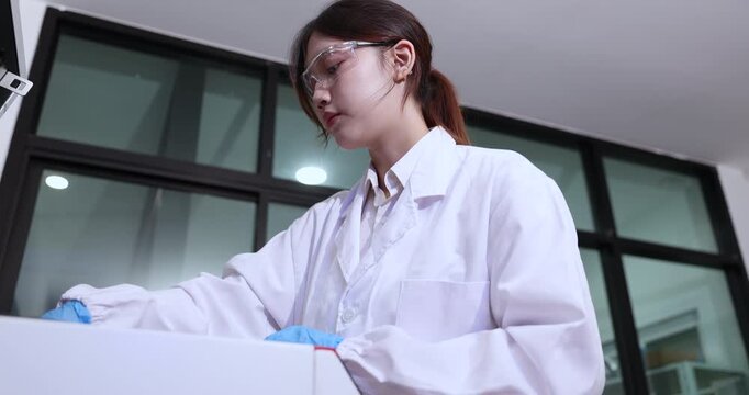 Scientist works in a laboratory using centrifuge to process samples at a research facility