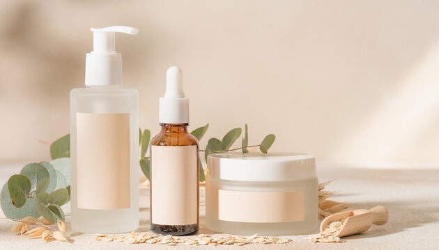 Natural skincare products with eucalyptus leaves and oats on a light background, minimalist beauty concept.