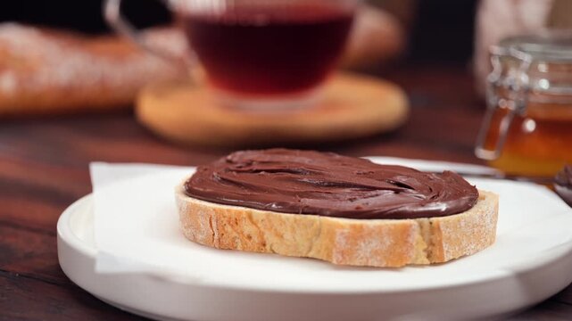 Chocolate spread on fresh bread slice close up homemade sweet breakfast
