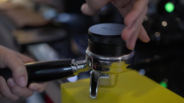 Manual coffee brewing with portafilter espresso machine, barista hand preparation, grinder and shot extraction, closeup of dark metal brewing equipment, cafe drink counter, coffee machine repair with