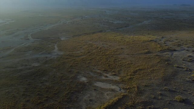4K drone view of Mount Bromo volcanic valley floor with off-road tracks in East Java, Indonesia.