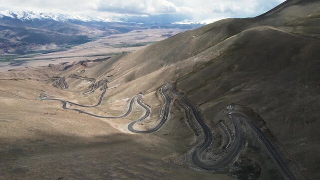 Winding Mountain Road Through Barren High Altitude Landscape