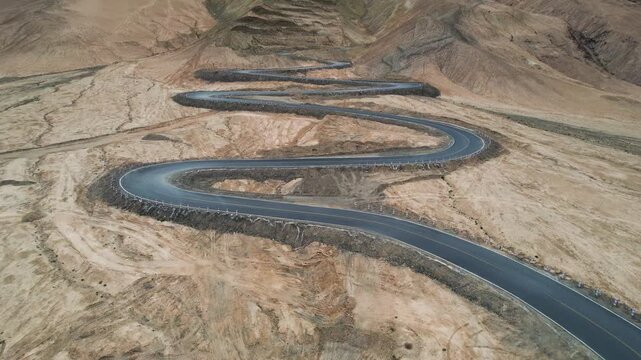 Winding Mountain Road Through Barren Desert Hills