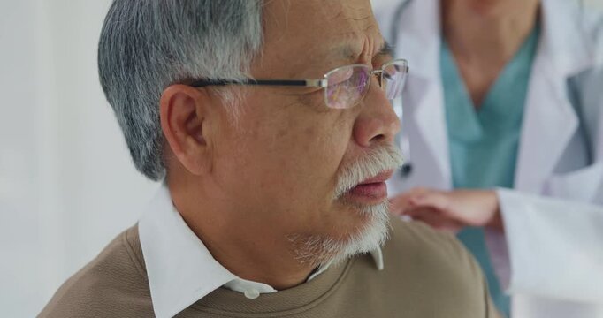 Closeup young Asian female doctor examining senior man with back pain at hospital clinic. Physical therapy treatment, health recovery consult, muscle ache relief, expert physician diagnosis concept.