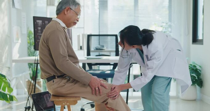 Young Asian female doctor examining senior man injured knee at hospital clinic. Physical therapy treatment, joint arthritis pain recovery, osteoarthritis medical care, physician consult concept.