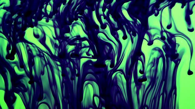 Dark purple ink swirls elegantly through bright neon green liquid in a mesmerizing slow motion sequence creating abstract flowing patterns