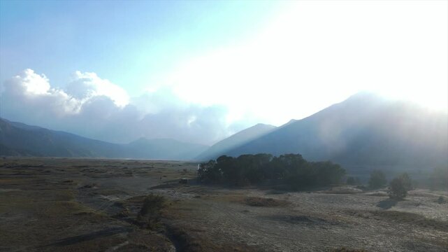 Wide 4K cinematic view of the vast volcanic sand sea at Mount Bromo caldera, East Java, Indonesia.