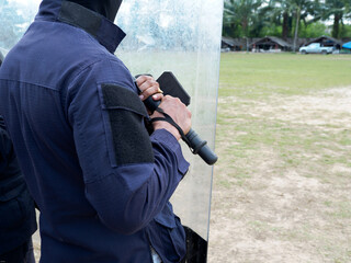 Fototapeta premium Riot police control the crowd practice and review on the grass field.