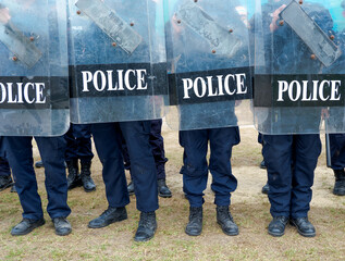 Fototapeta premium Riot police control the crowd practice and review on the grass field.