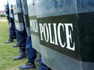 Fototapeta premium Riot police control the crowd practice and review on the grass field.