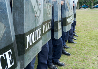 Fototapeta premium Riot police control the crowd practice and review on the grass field.